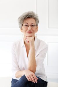 Happy woman in white with a beautiful smile